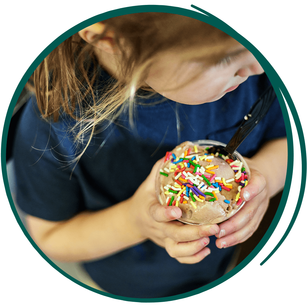 young girl holding an ice cream with sprinkles